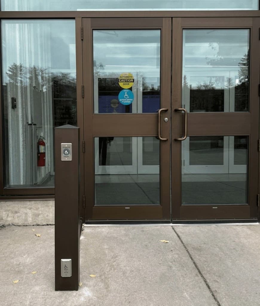 Commercial entrance with automatic accessibility door and wheelchair-activated push buttons